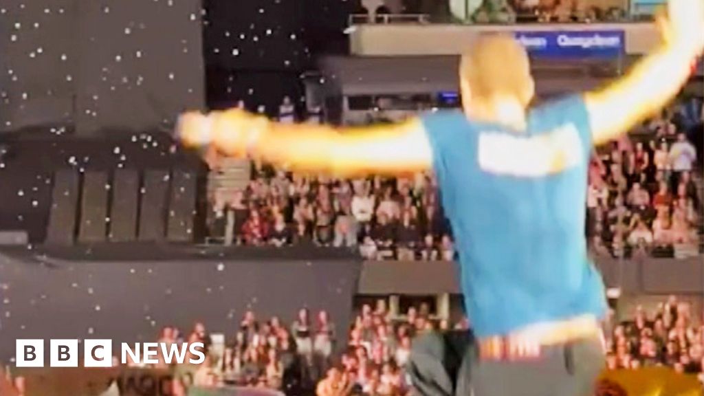 Moment Coldplay's Chris Martin falls through stage